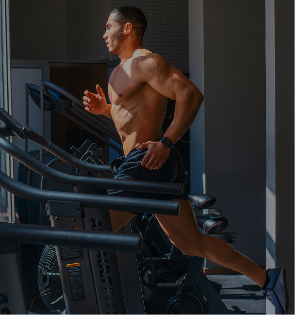 Man running on treadmill in gym workout scene
